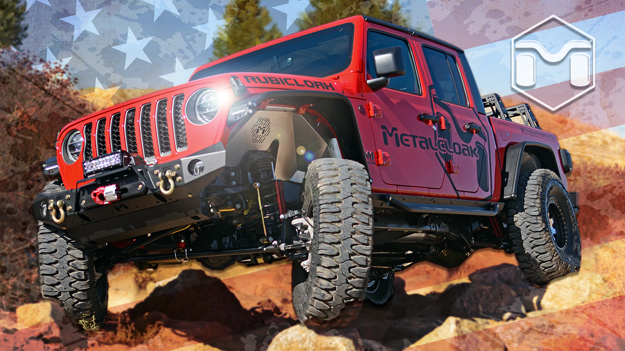 red Jeep JT Gladiator truck with black MetalCloak decals driving over rocks on rural dirt trail with American flag